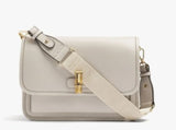 A light beige leather crossbody bag with a matching fabric strap and gold-tone hardware, shown on a clean white background.