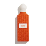 Orange perfume bottle with white cap on a white background