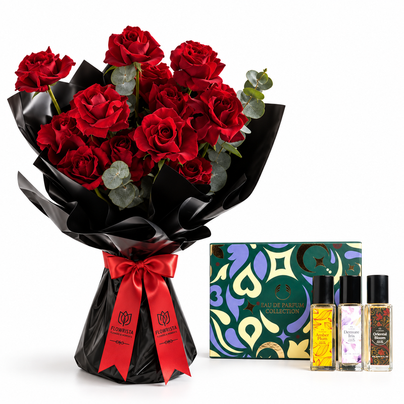 A bouquet of 24 red roses with green eucalyptus stems, wrapped in black paper with a red ribbon, displayed next to a 'Flowerilla Collection' perfume gift set containing three small fragrance bottles and a decorative box.