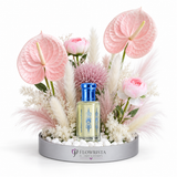 Al Khitam Musk perfume oil by Abdul Samad al Qurashi with pink anthurium, ranunculus, allium and pampas grass in Flowrista silver mirrored tray — luxury floral gift set Dubai