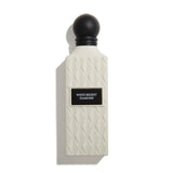 Perfume bottle with textured design and black cap on a white background