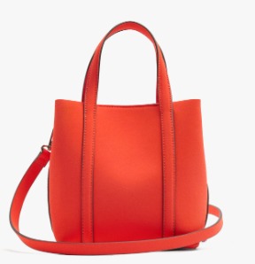 A bright orange-red leather handbag with dual top handles and a matching shoulder strap, shown against a plain white background.