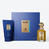 Blue Ocean Body Oud fragrance gift set featuring a blue shower gel tube, a blue box with a gold label, and a small clear glass perfume bottle filled with amber liquid, all on a light gray background.