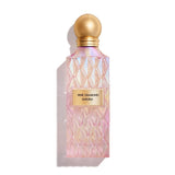 Perfume bottle with pink diamond pattern and gold cap on a white background