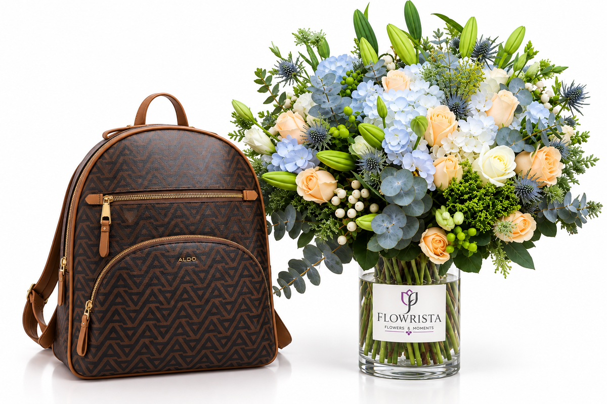 A brown patterned backpack with tan leather trim stands next to a large, vibrant flower bouquet in a clear glass vase labeled FLOWWRISTA, set against a clean white background.