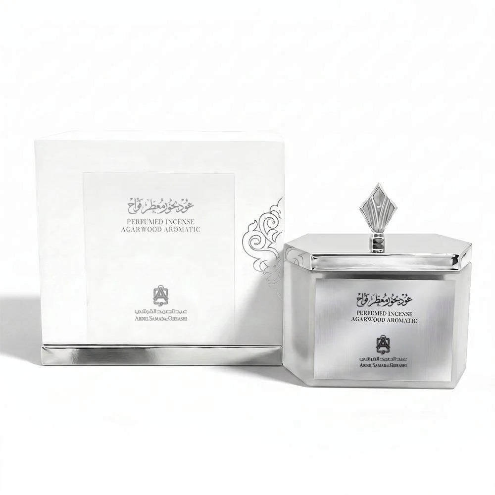 Silver incense container with decorative design and white box on a white background