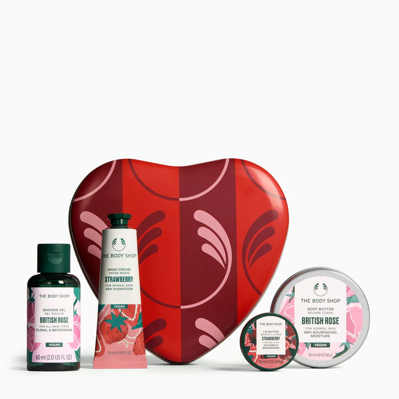Collection of The Body Shop products including a heart-shaped tin, bottle, and containers on a white background.