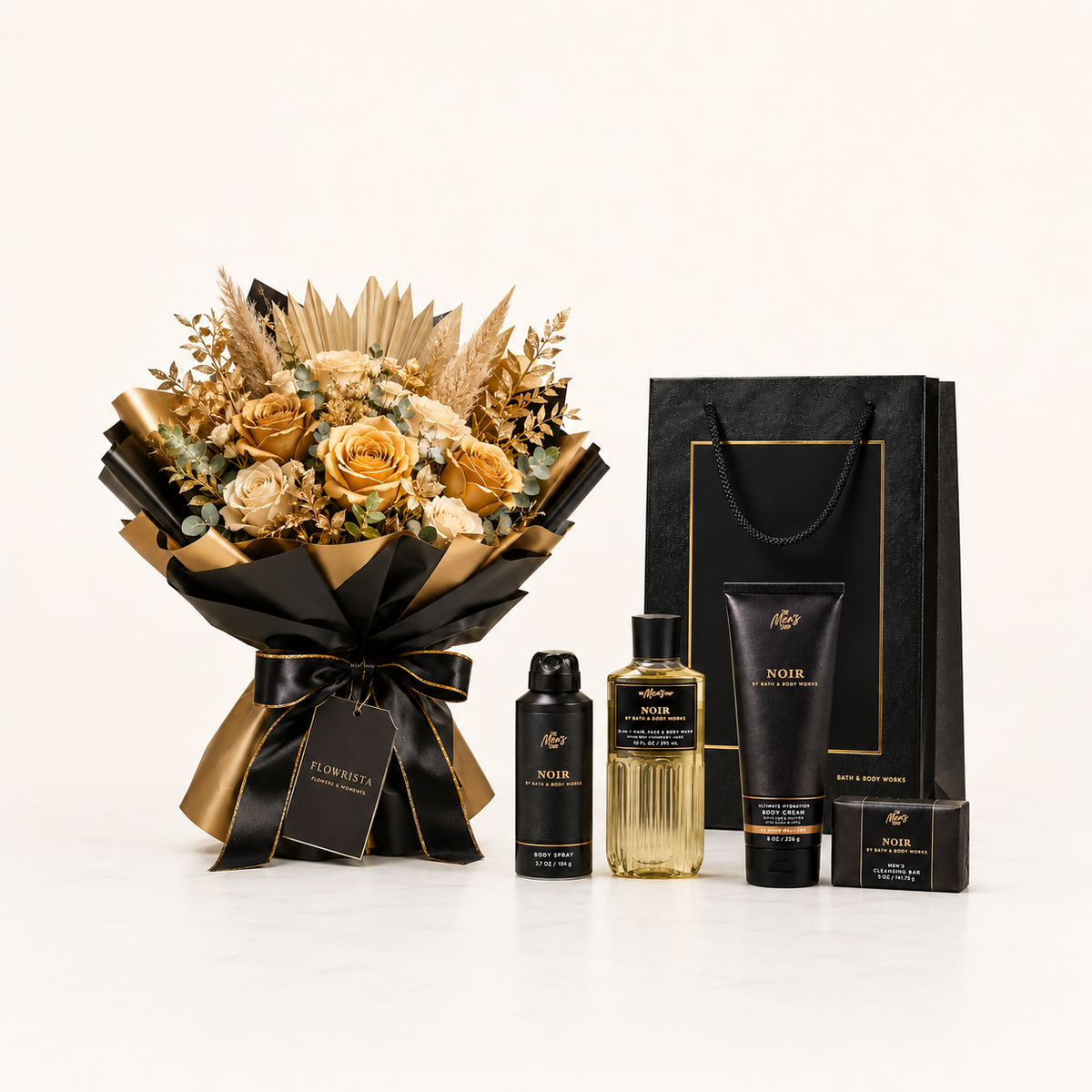 A luxury gift set featuring a dried flower bouquet in black and gold wrapping, alongside a black shopping bag and skincare products including a bottle, tube, and box labeled NOIR.