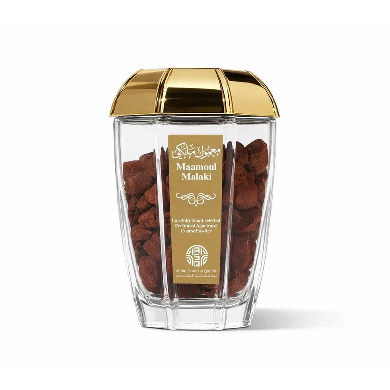 Clear container with gold lid holding Maamoul cookies on a white background
