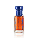 Perfume bottle with blue cap and orange liquid on a white background