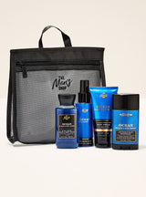 Men's grooming products with a black travel bag labeled 'The Men's Shop' on a beige background.