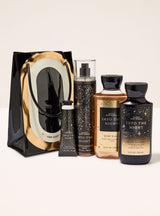 Set of bath and body products with 'Into the Night' packaging on a white background