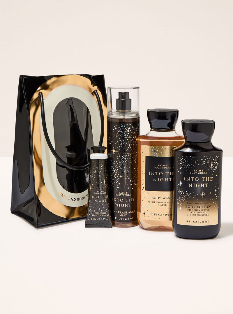 Set of bath and body products with 'Into the Night' packaging on a white background