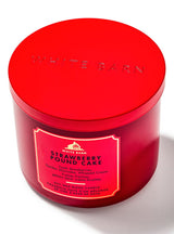 Red candle jar with 'White Barn' branding and 'Strawberry Pound Cake' label on a white background
