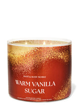 Bath & Body Works Warm Vanilla Sugar soy wax candle in a clear glass jar with a red and gold glittery label, shown on a white background.