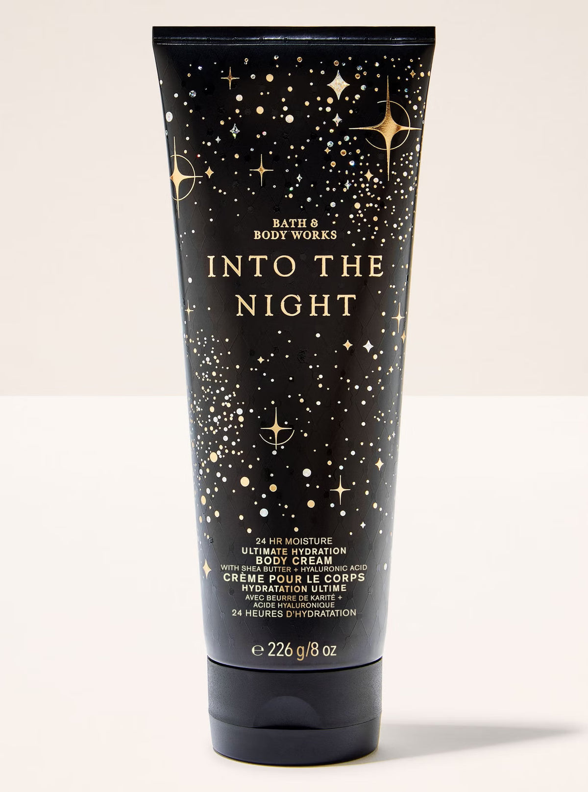 Body cream tube labeled 'Into the Night' by Bath & Body Works on a white background