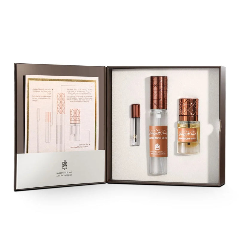 Perfume set with three bottles and a leaflet in an open box on a white background