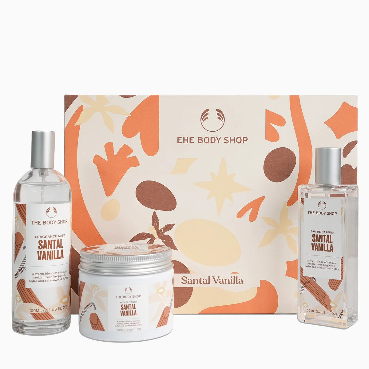 The Body Shop Santal Vanilla gift set featuring a fragrance oil bottle, a body cream jar, and a body wash bottle arranged in front of a decorative Santal Vanilla gift box on a white background.