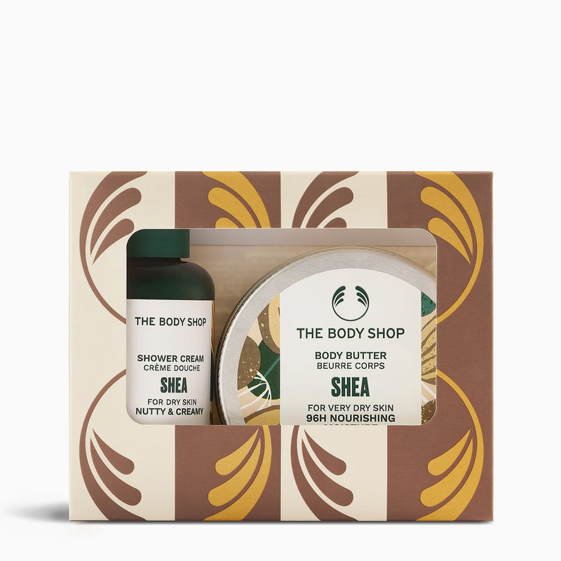 The Body Shop Shea Body Butter and Shower Cream gift set in a patterned box with a clear window showing the products inside.