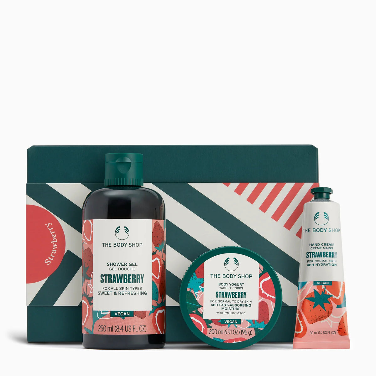 The Body Shop Strawberry product set including shower gel, body scrub, and hand cream on a white background.