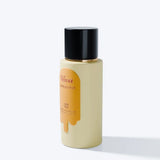 Beige bottle with black cap on a white background