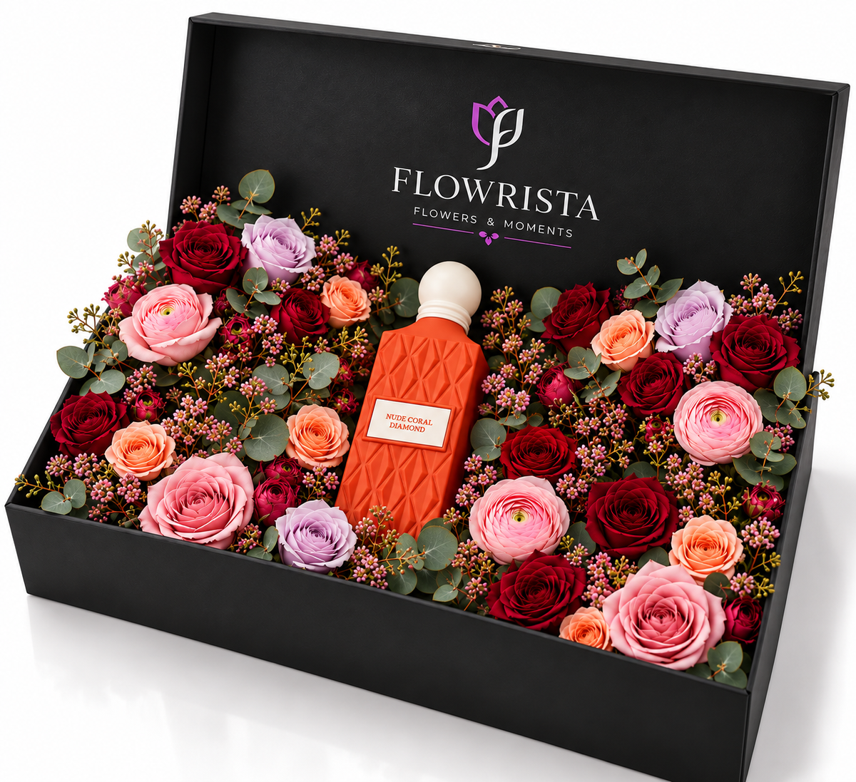 A luxury floral gift box by Flowrista containing a central orange perfume bottle surrounded by an assortment of red, pink, and purple roses with green foliage, presented in an open black box.