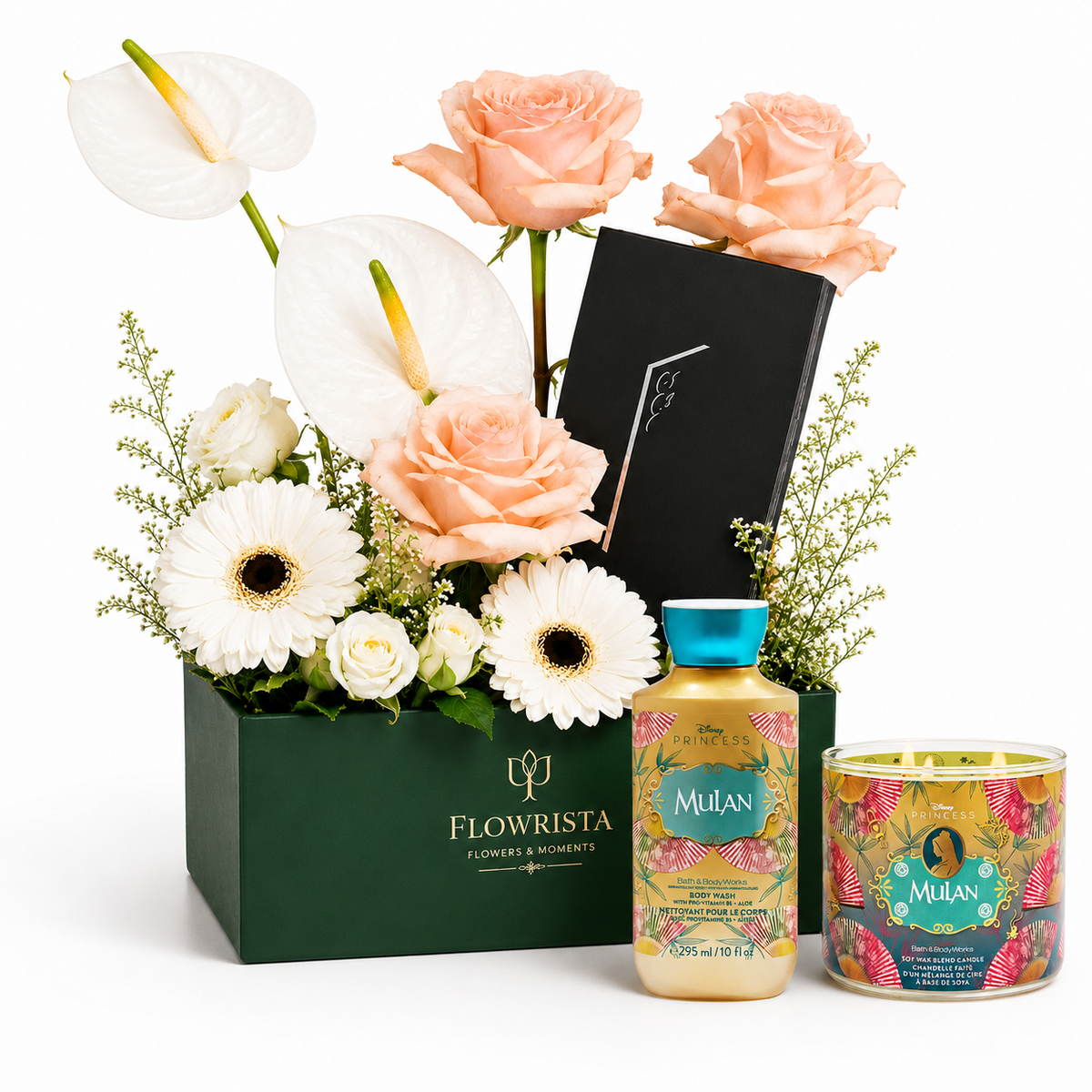 A curated gift set featuring a dark green box of flowers from Flowrista, including peach roses, white anthuriums, and daisies, alongside a bottle of Mulian body wash and a matching candle tin on a white background.