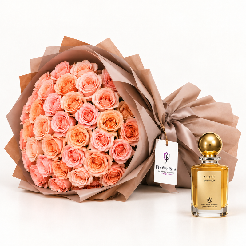 A bouquet of peach and pink roses wrapped in brown paper with a bow, next to a small perfume bottle labeled ALLURE ROSE OIL, on a clean white background.