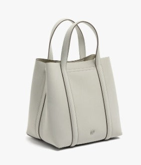 A light gray leather tote bag with dual top handles, shown from a three-quarters angle against a clean white background.