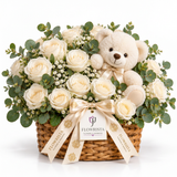 White rose and baby's breath basket with eucalyptus, cream teddy bear and Flowrista ribbons