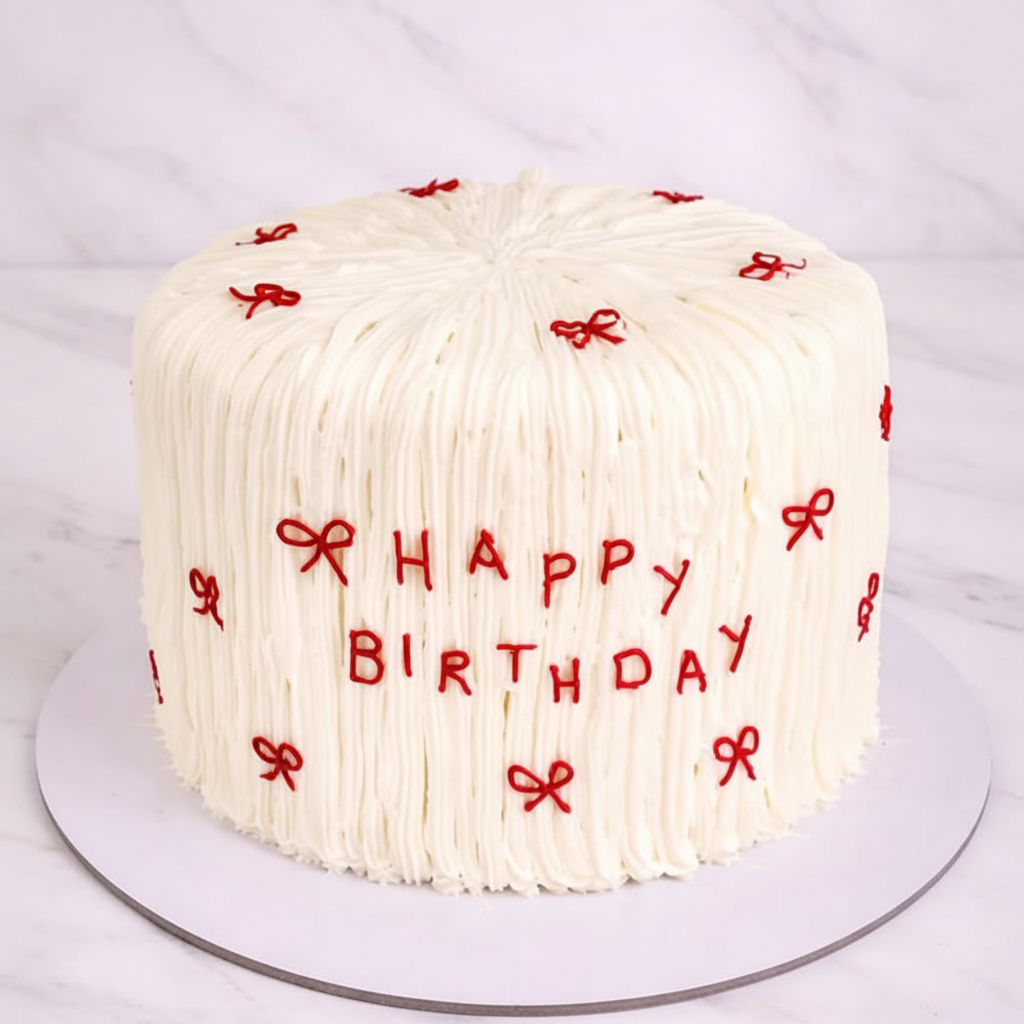 One-kilo Sugar Sweet ivory-white birthday cake with red bows and Happy Birthday message