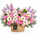 Flowrista wicker basket of white gerberas, pastel roses, pink chrysanthemums, peach carnations and lavender stock