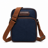 ALDO navy crossbody bag with brown strap and front zip pocket