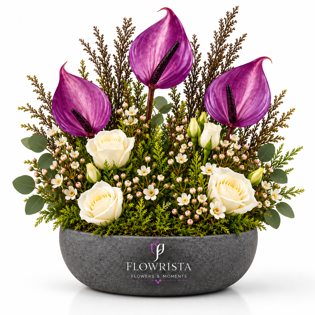 Artificial purple anthuriums and white roses with decorative foliage in a grey oval Flowrista bowl