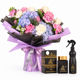 Ashek Al Oud bakhoor and Ashiq Aloud air freshener beside a hydrangea and pink rose bouquet