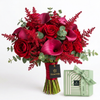 Red and burgundy Flowrista bouquet with eucalyptus beside a mint green Patchi chocolate box