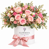 Pink roses and white lisianthus in a white Flowrista box with pink satin bow
