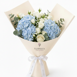 Flowrista blue hydrangea and white roses bouquet in cream branded paper with white satin ribbon
