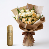 Arabian Tobacco 100 ml gold perfume bottle beside a white and peach rose bouquet with Flowrista wrapping