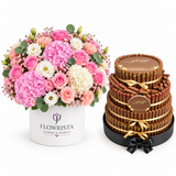 Italian Fine Fair Pyramid Jumbo chocolate arrangement beside Flowrista pink rose and hydrangea flower box