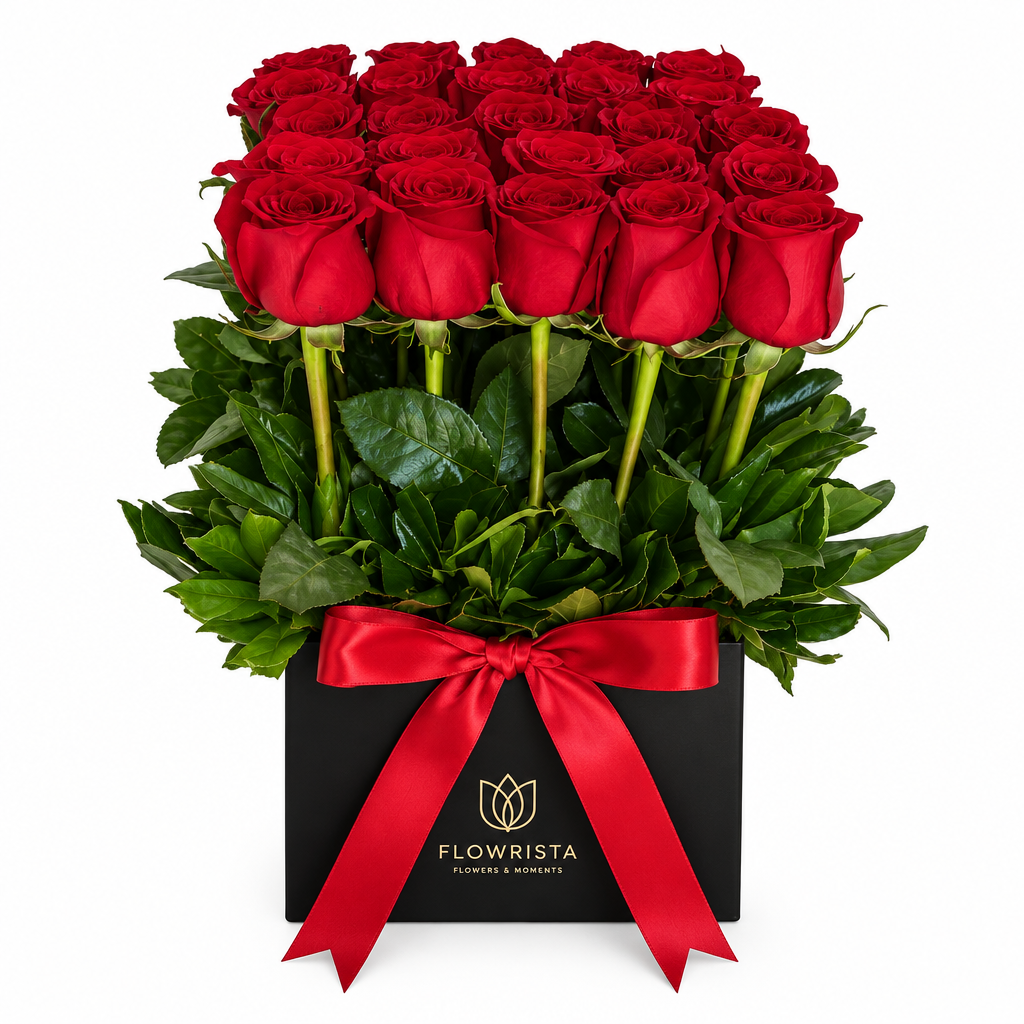 Fresh red roses with green foliage in a black square Flowrista flower box with red satin ribbon