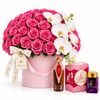 Asser perfume and Bakhoor Saher Alkalmet beside Flowrista pink roses and white orchids in a pink flower box