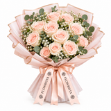Peach-pink roses and gypsophila in Flowrista blush wrap with peach ribbon