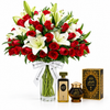 Kuwaiti perfume and Bakhour Kuwati beside Flowrista red roses and white lilies in a clear glass vase