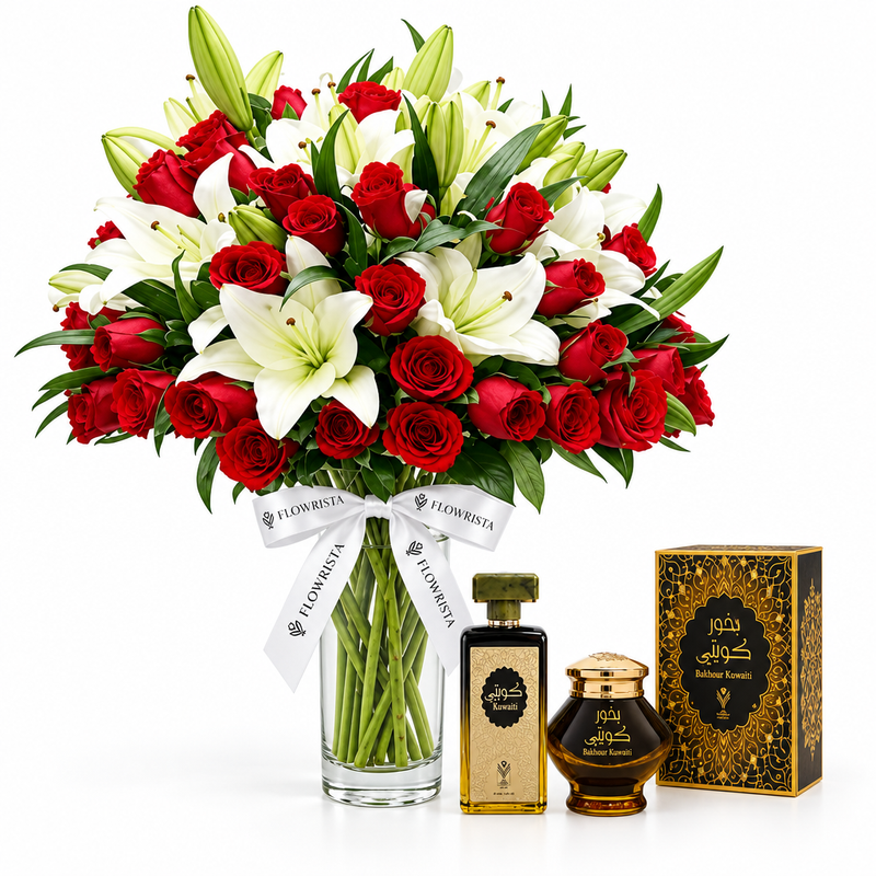 Kuwaiti perfume and Bakhour Kuwati beside Flowrista red roses and white lilies in a clear glass vase