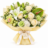 Flowrista white and green bouquet with cream roses, lily, hydrangea, orchid and anthurium in pale yellow wrapping
