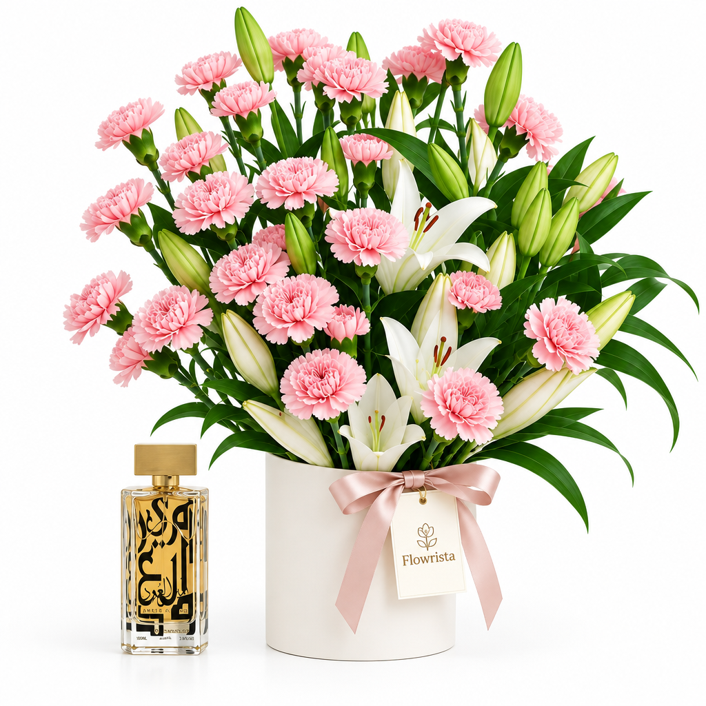 Amir Al Oud Gold perfume beside Flowrista pink carnations and white lilies in a white flower container