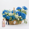 Pink Diamond Sakura perfume beside a blue and white floral basket with navy ribbon and Flowrista tag