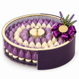 Giovanni luxury oval acrylic chocolate box with purple and white chocolates, gold rim and ribbon