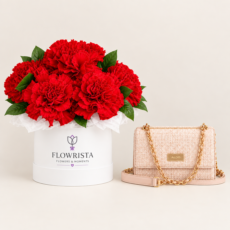 ALDO Bellarose pink crossbody beside red carnations in a white Flowrista flower box